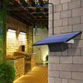 Wall lamp with solar cells and separate panel